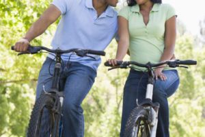 Couple on bikes outdoors smiling