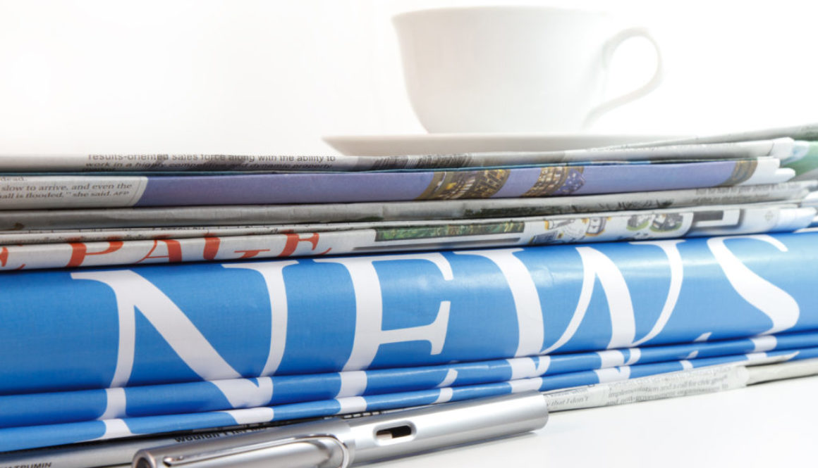 a coffee cup and newspaper background